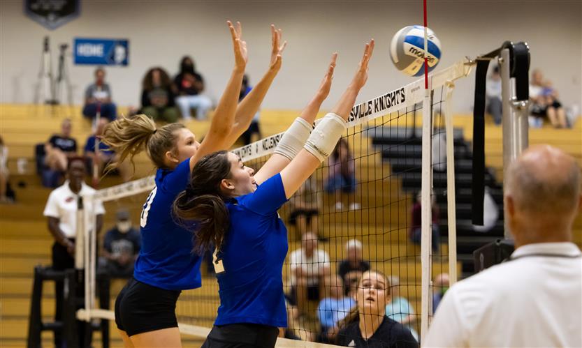 High school students play volleyball